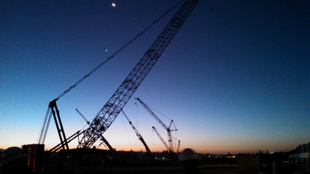 Tower cranes at the massive Apple Campus 2 project at sunrise. 